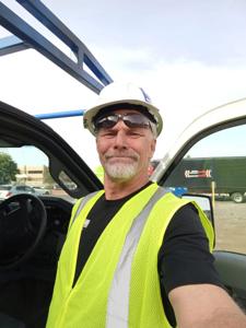 Professional technician in safety gear at commercial job site