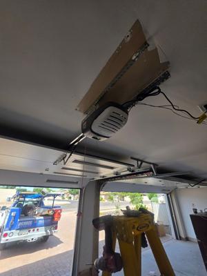 After — Dual Garage Door Installation with Genie Openers and Glass Panels