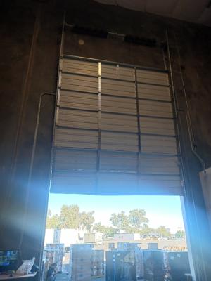 Before — Commercial Roll-Up Door Repair after Forklift Impact