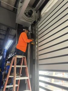 Technicians at work on garage door installation